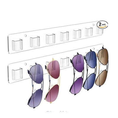 Two clear wall sunglasses racks; one holds five pairs of sunglasses with different lens tints