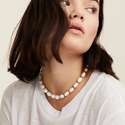 A woman wearing a Bold Pearl Necklace