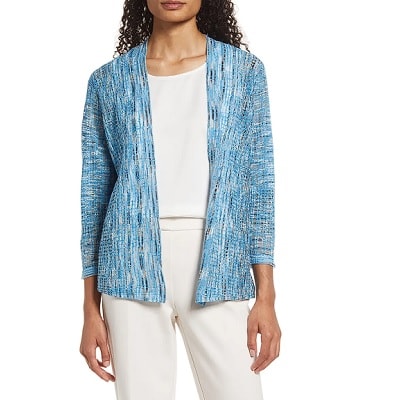 woman wears blue cardigan with white top and white pants