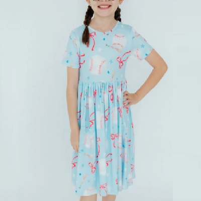 A girl wearing a light blue baseball-print dress