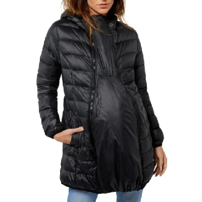 A pregnant woman wearing a black puff maternity jacket