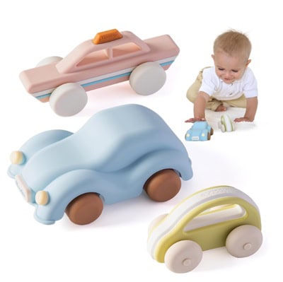 Three silicone toy cars next to a baby playing with a blue toy car