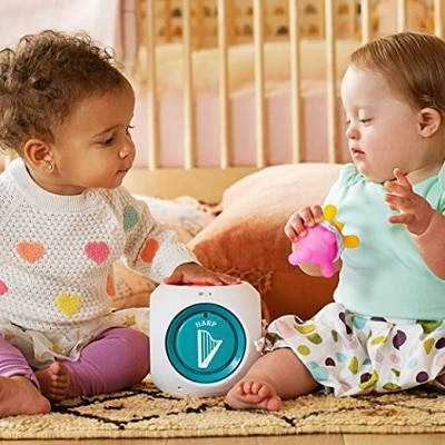 two babies playing with Mozart Magic Cube