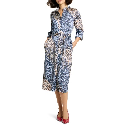 A woman wearing a blue printed long sleeve shirt dress