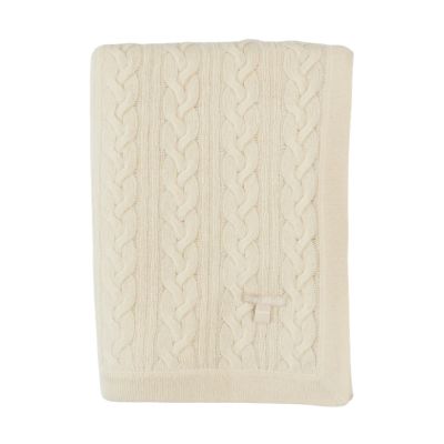 An off-white, cable-knit blanket