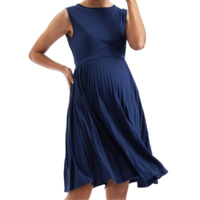 A pregnant woman wearing a navy pleated maternity dress