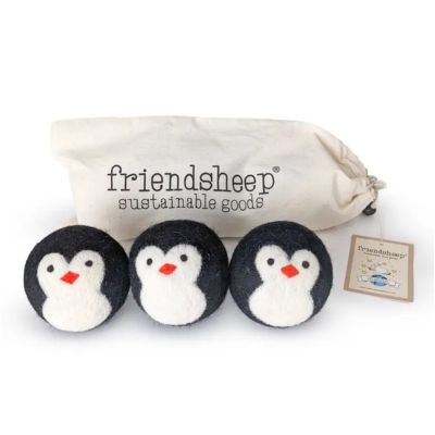 Three penguin dryer balls next to a carrying bag that reads "Friendsheep Sustainable Goods"