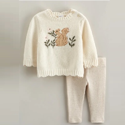 A white baby sweater featuring a squirrel, nd beige leggings