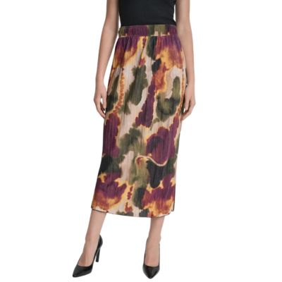 A woman wearing a black top, black pumps, and multicolored midi skirt