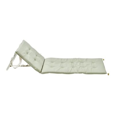 A light green padded beach recliner
