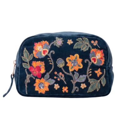 An embroidered floral makeup bag with a dark blue fabric