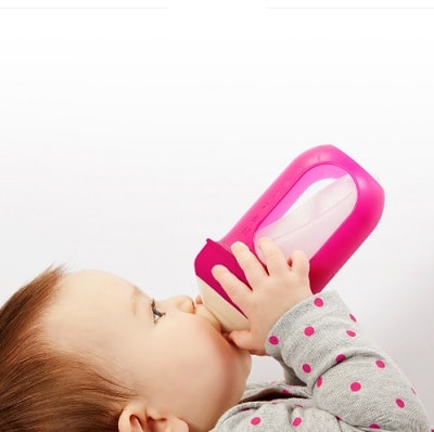 A baby drinking from a Nursh Reusable Silicone Pouch Baby Bottles 