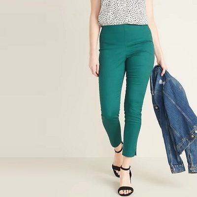 A woman wearing a pair of green High-Waisted Super Skinny Ankle Pants