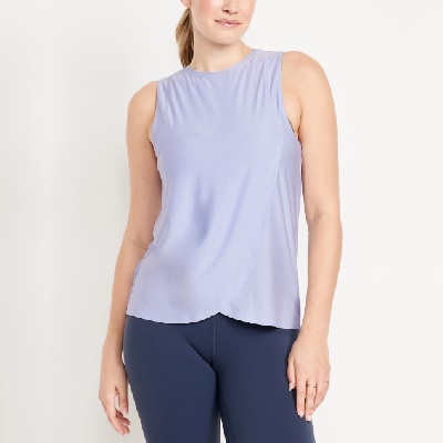 A woman wearing navy leggings and a periwinkle workout tank