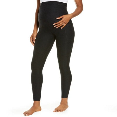 A pregnant woman wearing black maternity leggings