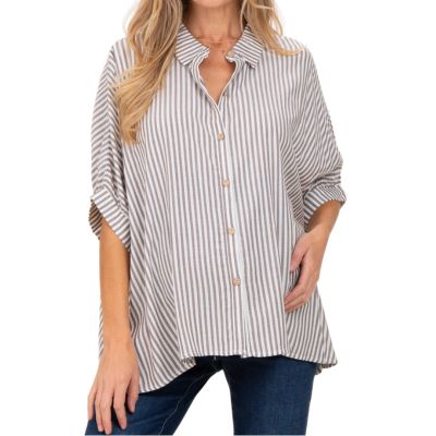 A woman wearing a brown-and-white striped button-front maternity shirt, with dark blue jeans