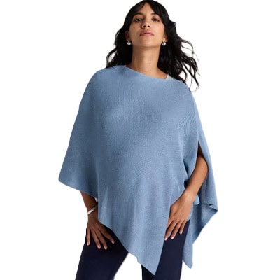 A woman wearing a cornflower blue nursing shawl and black pants