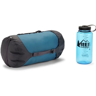 A blue compression sack and a blue REI water bottle
