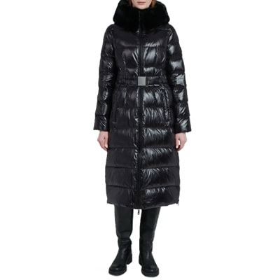 A woman wearing a long black puffer coat and black tall boots