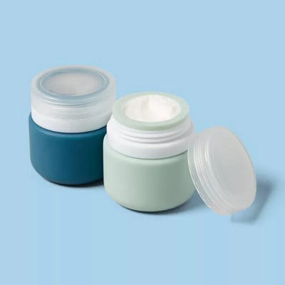 2 skincare reusable jars , one blue and one green