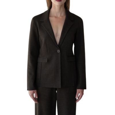 A woman wearing a brown blazer and brown pants