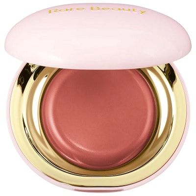A pink and gold container of cream blush with 