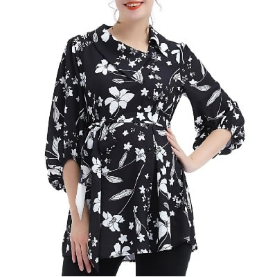 A lady wearing a black printed maternity blouse