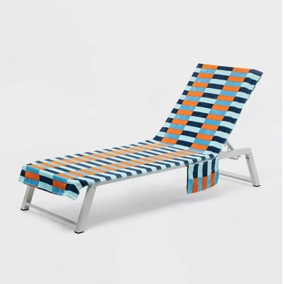 A striped beach towel on a lounge chair
