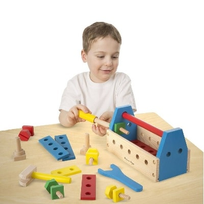 A child with a set of tool kit toys