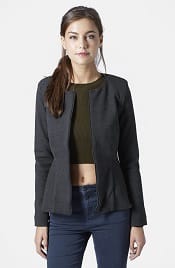 A woman wearing a Tailored Peplum Jacket