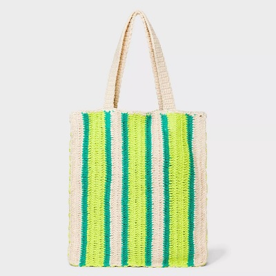 A crochet tote with green and yellow stripes on a natural background