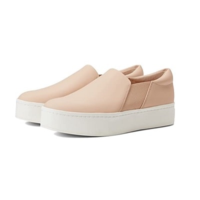 A pair of platform sneakers that are white on the bottom and peach on top
