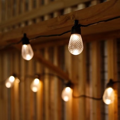 Outdoor string lights lit up on a deck