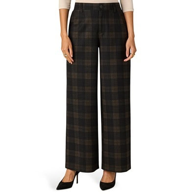 A woman wearing blue/brown plaid pants, an off-white top, and black pumps
