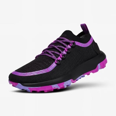 A black trail running shoe with purple trim