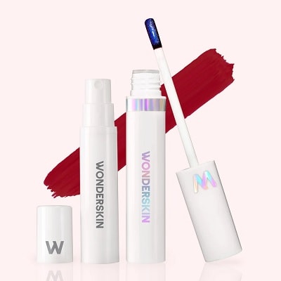 Two containers of Wonderskin Wonder Blading Lip Stain with the lids off, plus a swatch of a reddish shade behind it