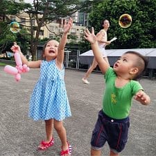 A picture of baby playing bubbles