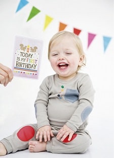 A baby smiling on his first birthday photoshoot