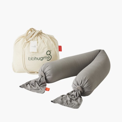 A gray pregnancy pillow and a white string bag