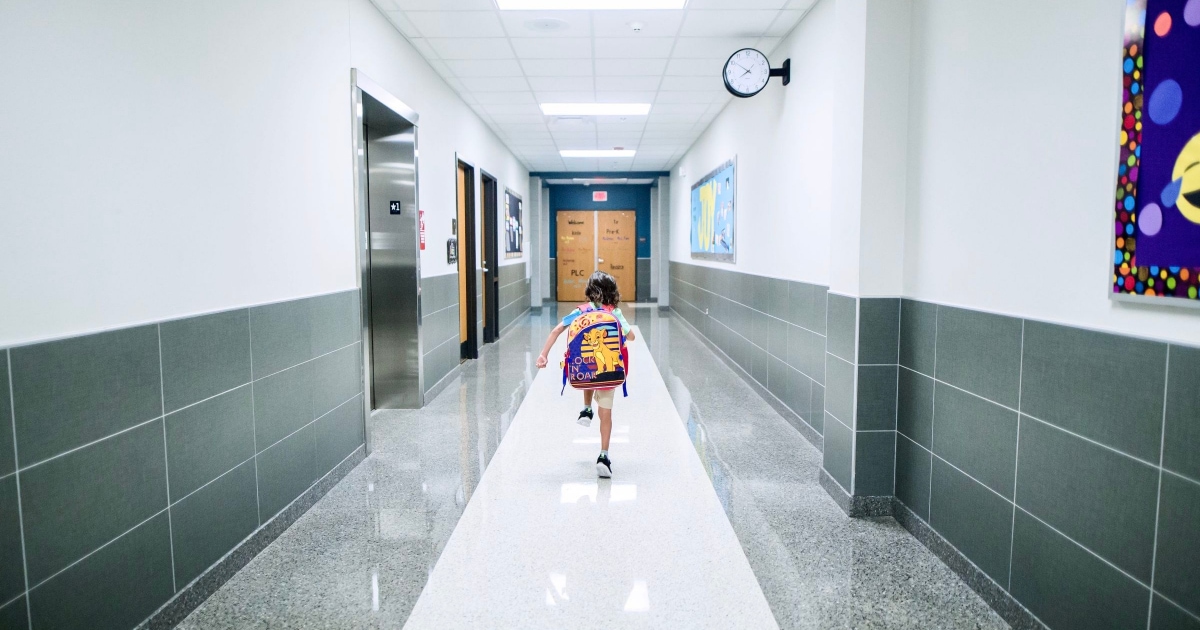 A child walking on a hallway