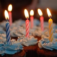 A birthday cupcake with lit candles