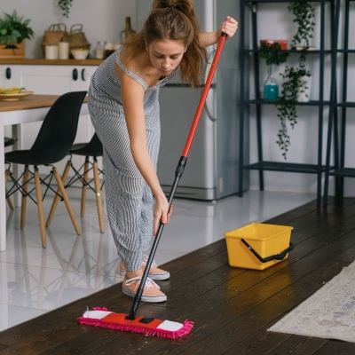 A photo of a lady cleaning using a mop