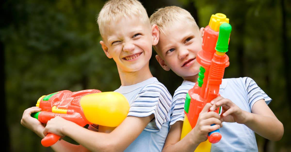 Two buys having fun with water guns