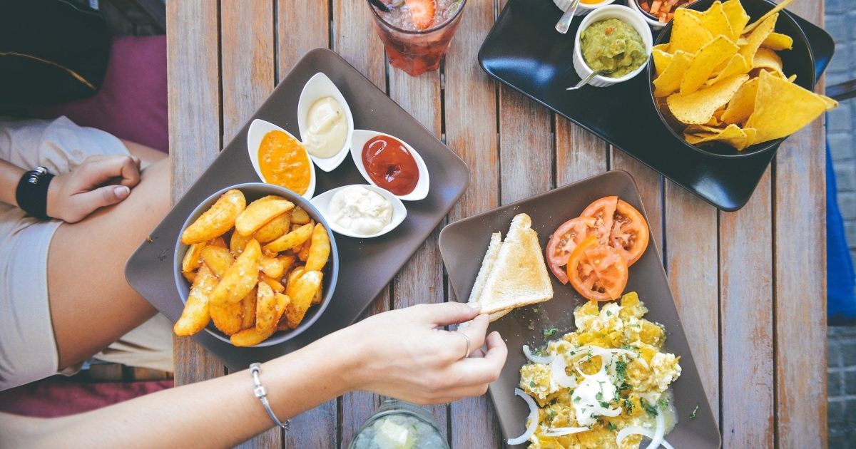 overhead shot of multiple appetizer foods on a dinner table