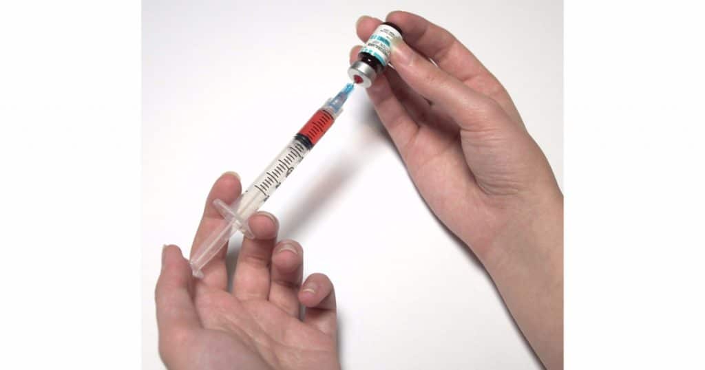 A person preparing an injection