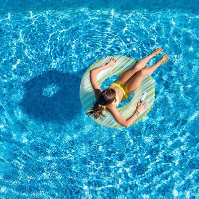 A woman in a blue pool of water