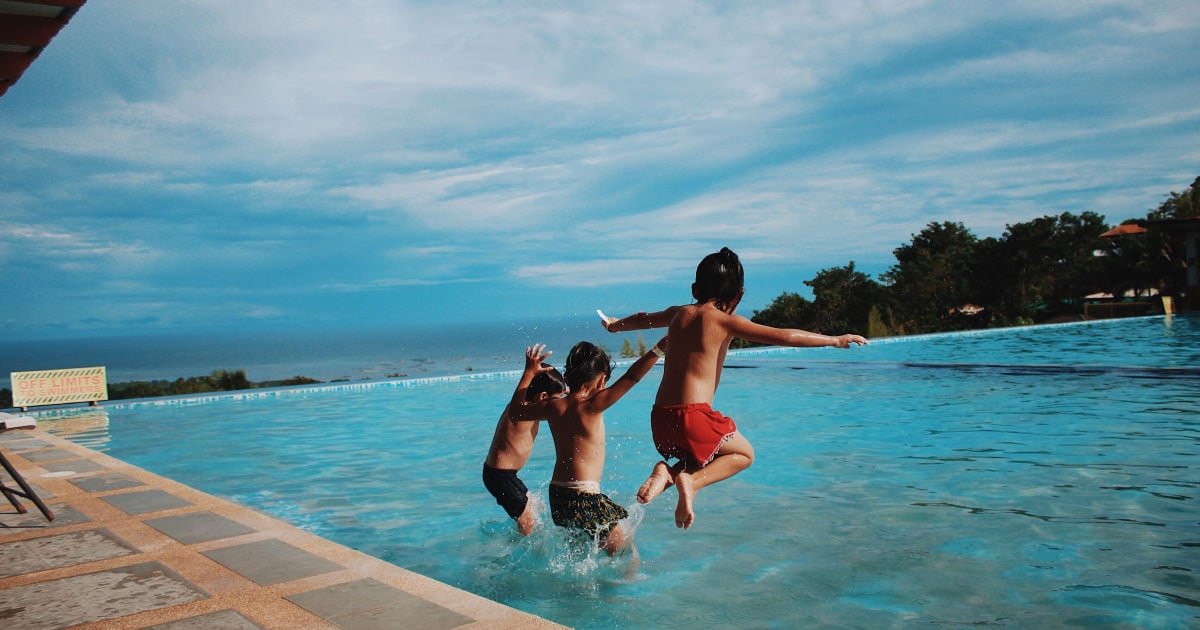 kids jumping into pool