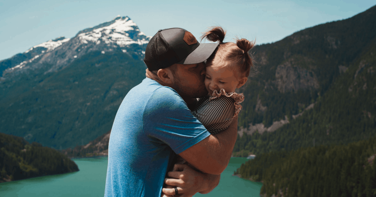 A father kissing his daughter