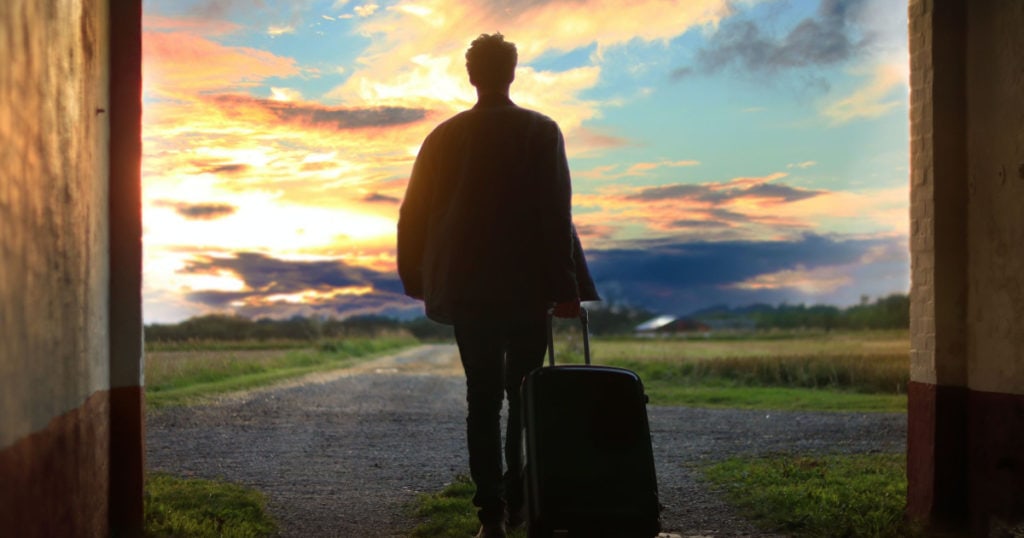 A man standing in front of a sunset