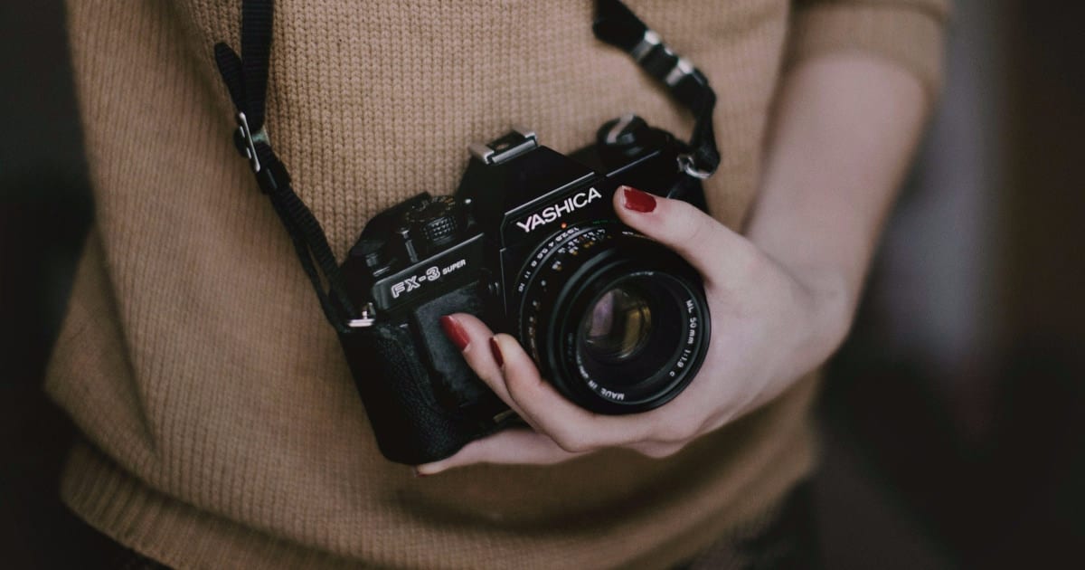 A woman holding a digital camera